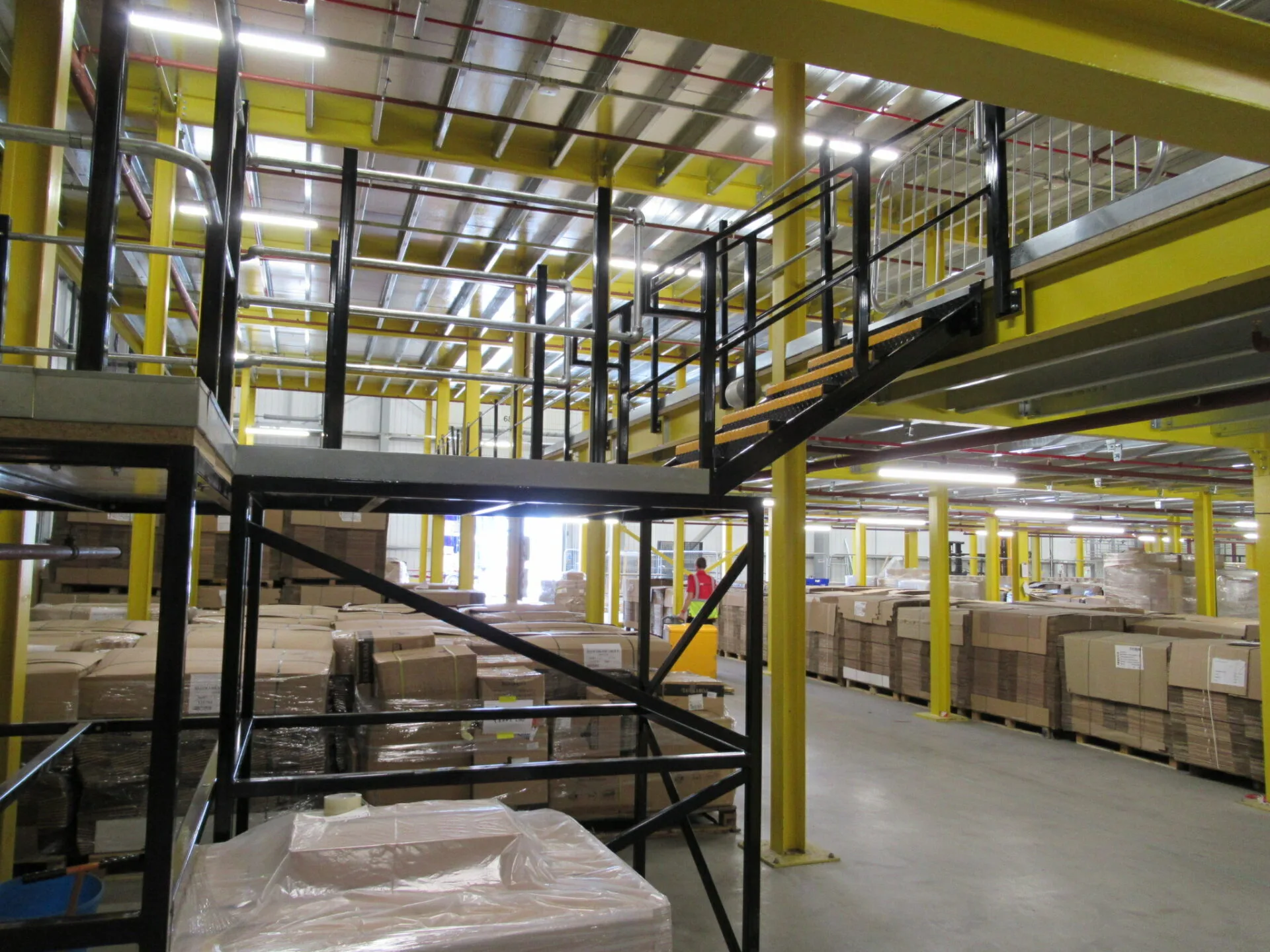 large automated warehouse with multi tier mezzanine