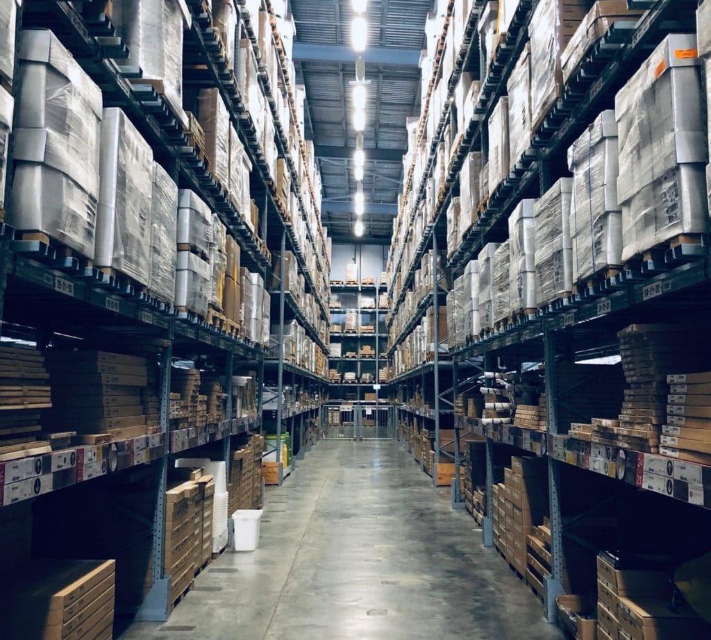 warehouse aisle with pallets and boxes on both sides