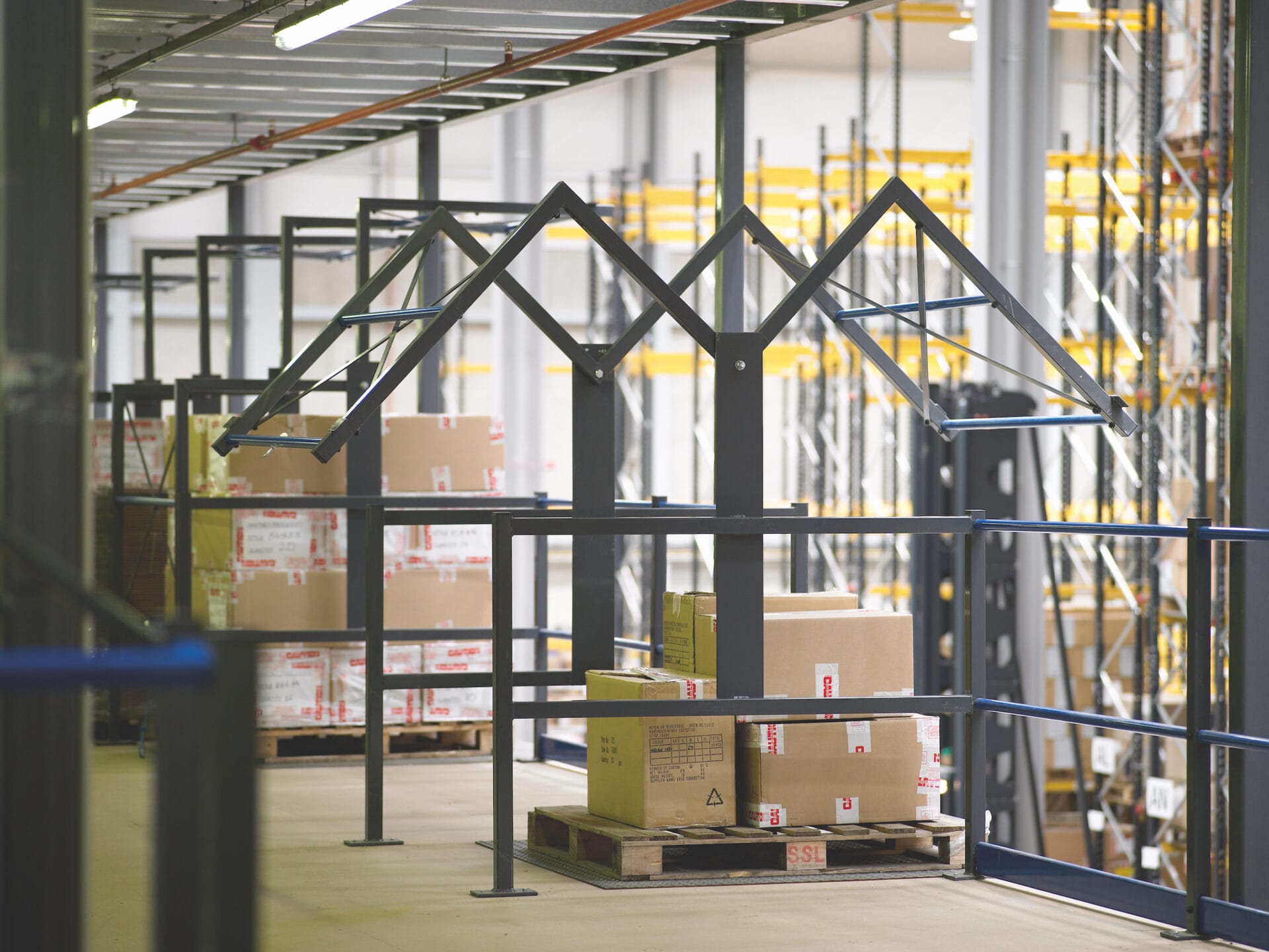 mezzanine floor pallet gate containing pallet of boxes