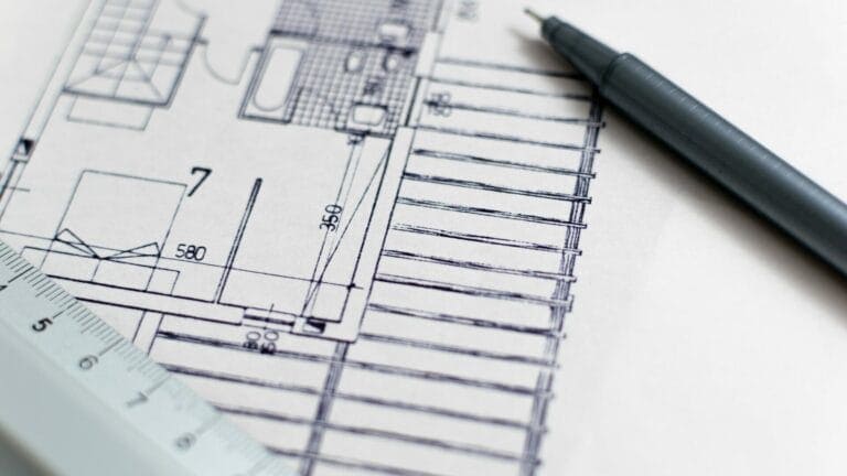 close up of portion of autocad drawing with pen and ruler