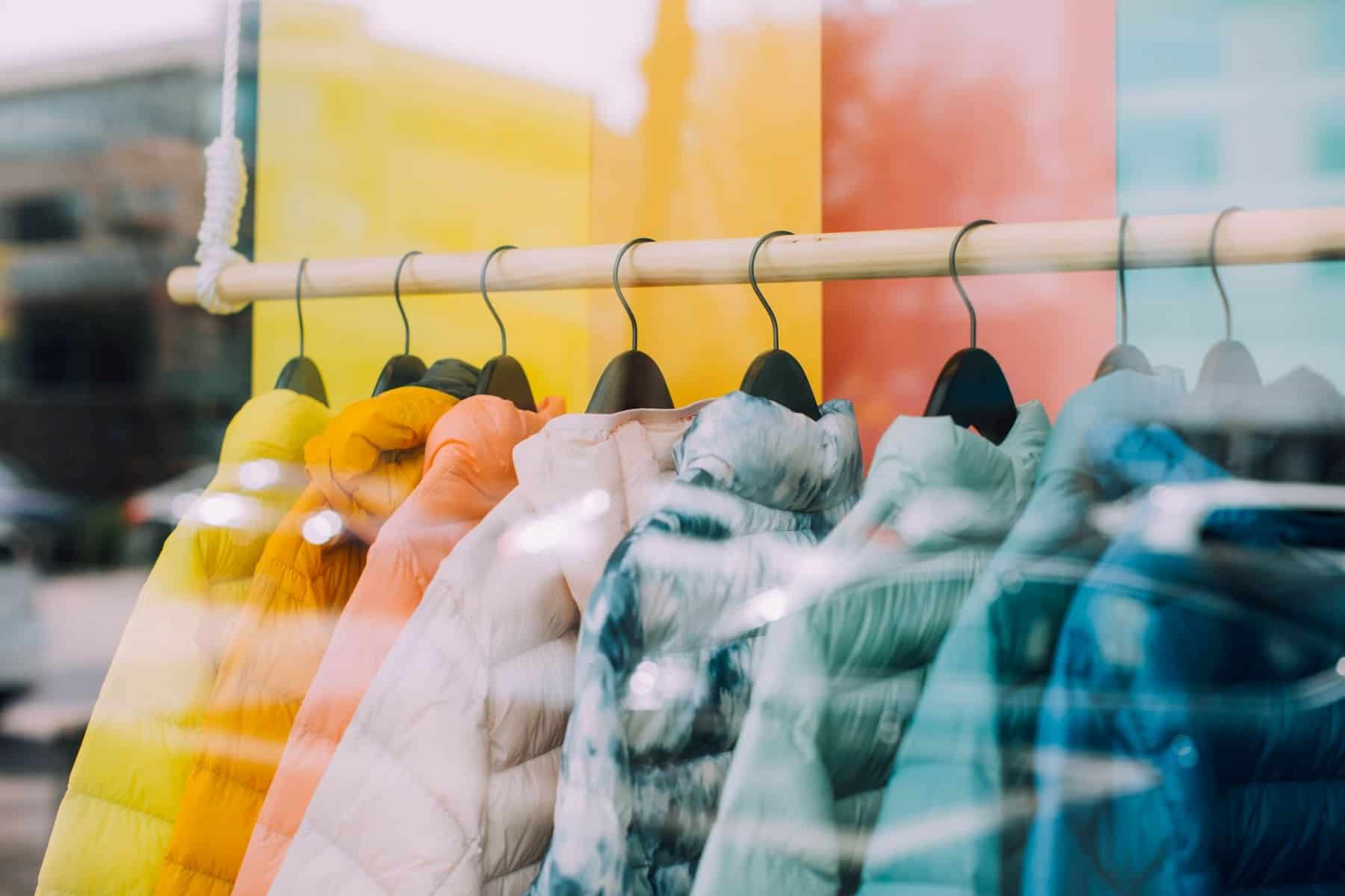 multi coloured coats on hanging rack