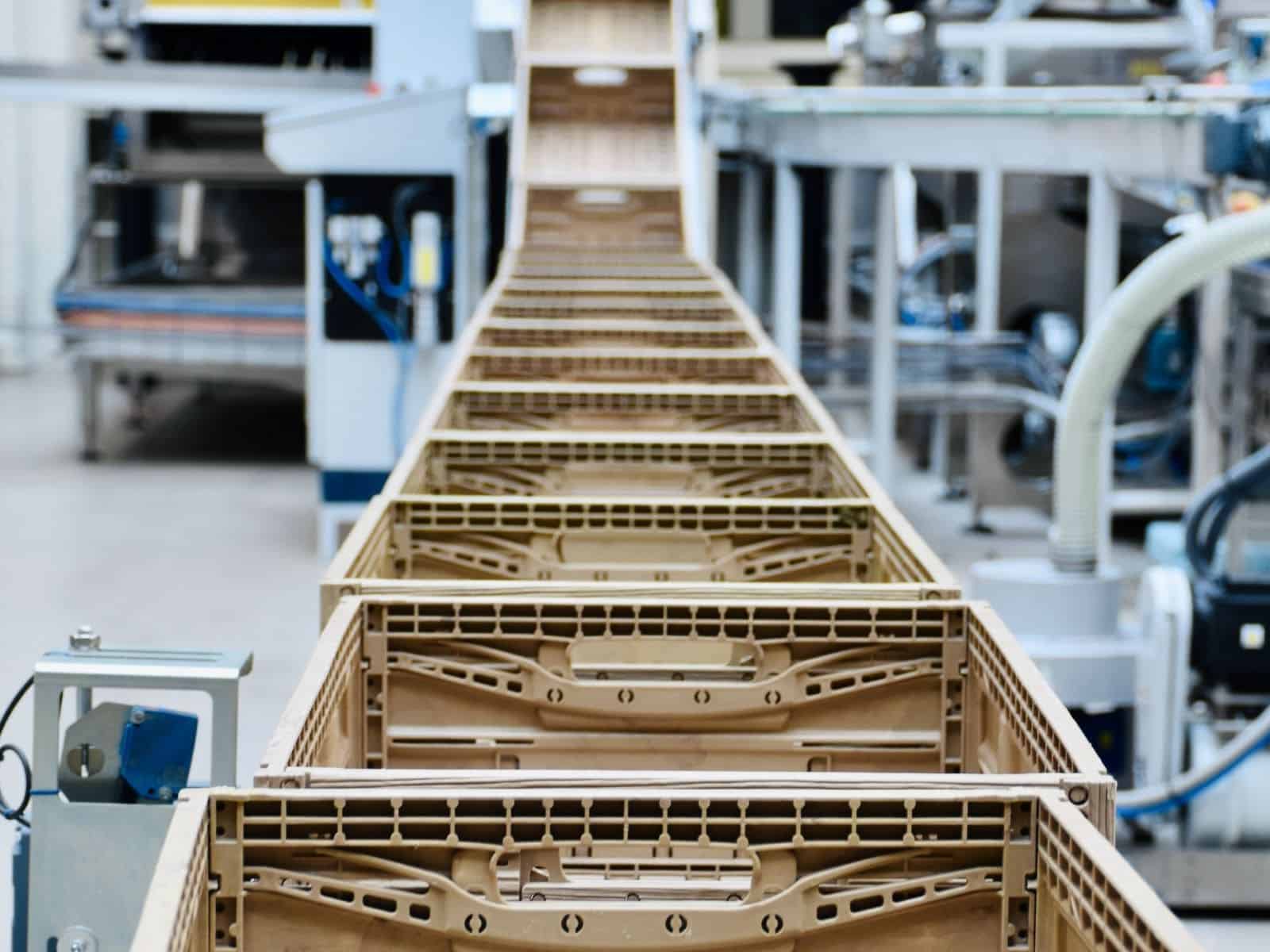 empty tote boxes in a line on conveyor