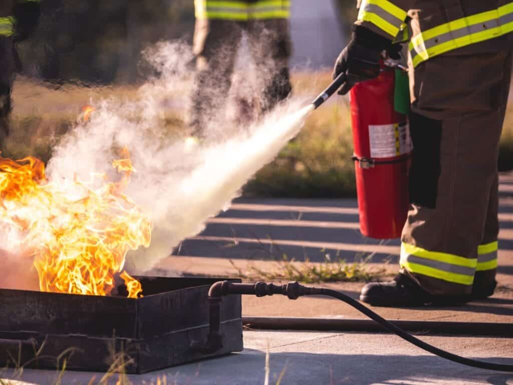 person extinguishing small fire