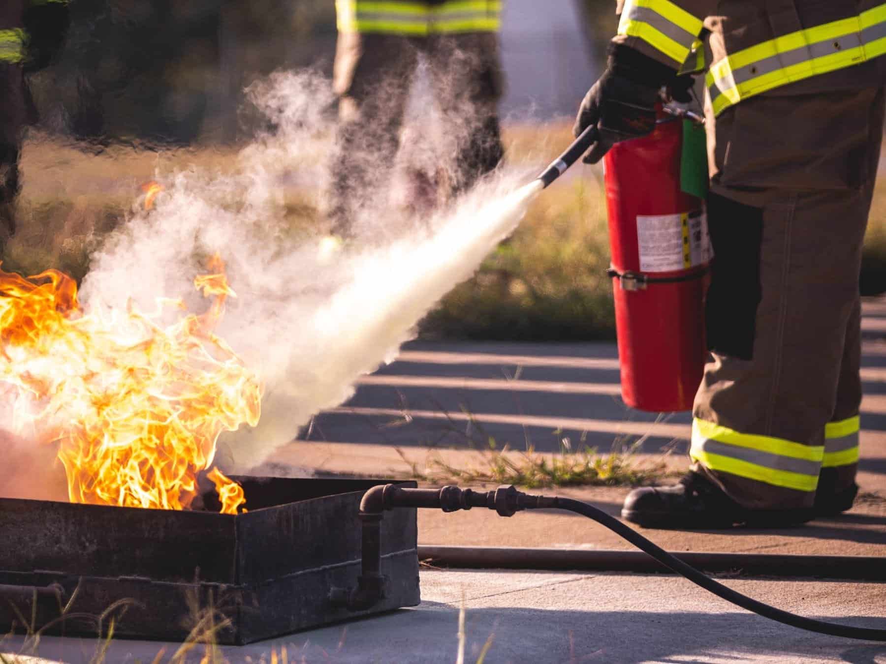 person extinguishing small fire