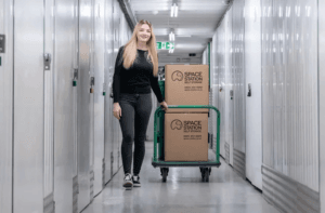 space station self storage customer with boxes on trolley