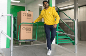 space station self storage customer with boxes on trolley
